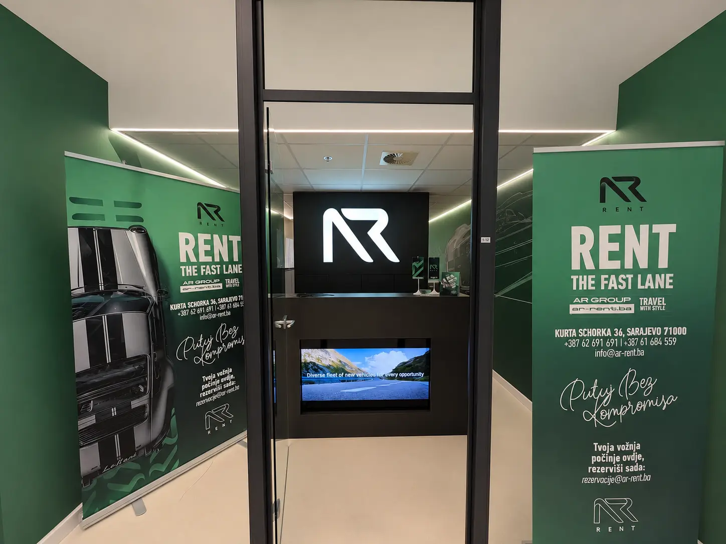 AR Rent a Car Sarajevo airport office entrance with branded roll-ups at Sarajevo Airport (SJJ)